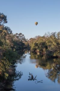 The napa river with a hot air balloon floating by